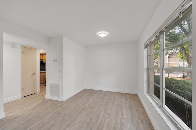 unfurnished room with light hardwood / wood-style floors