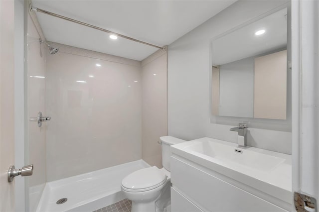 bathroom with tile flooring, a shower, large vanity, and toilet