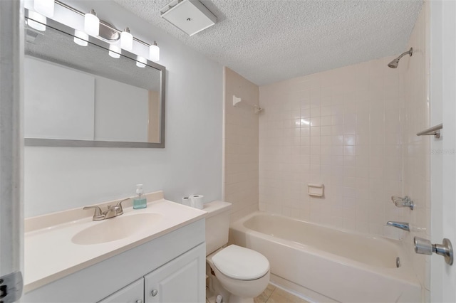 full bathroom with tiled shower / bath combo, tile flooring, a textured ceiling, toilet, and oversized vanity