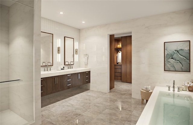 bathroom with tile walls, walk in shower, tile floors, and dual bowl vanity