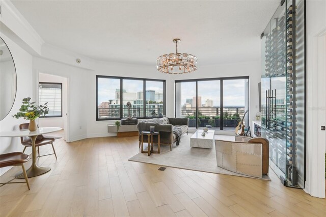 living room with a notable chandelier and light wood-type flooring