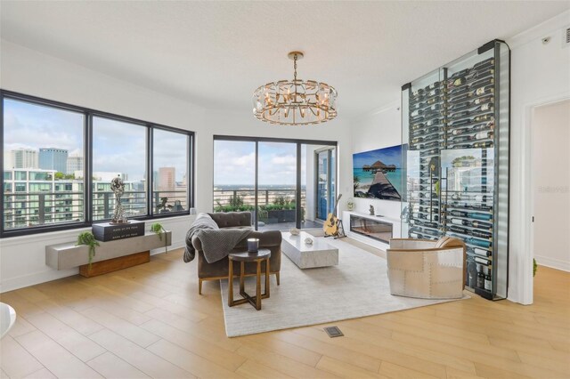 living room with a chandelier and light hardwood / wood-style floors