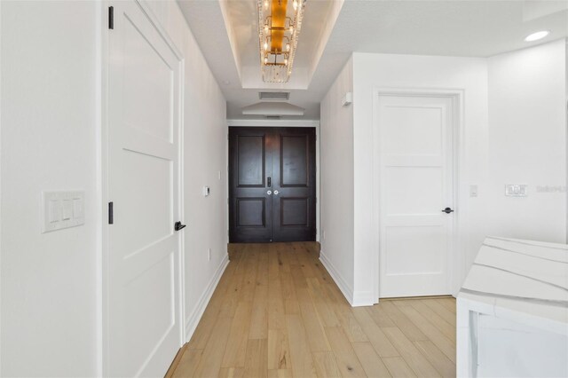 hallway with light hardwood / wood-style floors