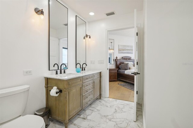 bathroom featuring vanity, toilet, and wood-type flooring