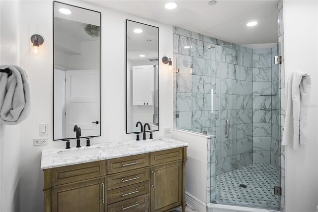 bathroom with vanity and a shower with door