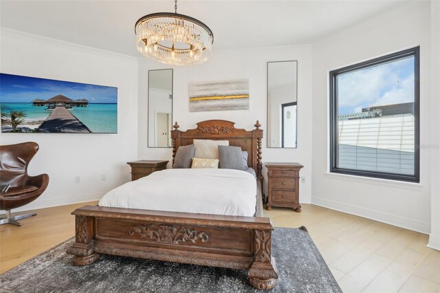 bedroom with hardwood / wood-style flooring and a chandelier