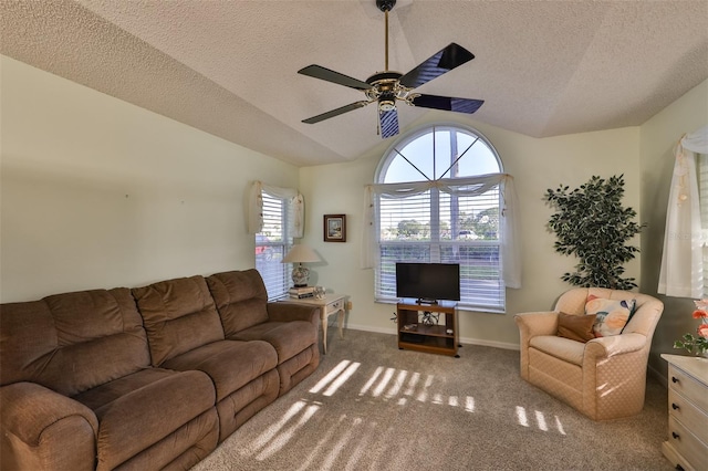 living room with carpet flooring, a textured ceiling, ceiling fan, and vaulted ceiling