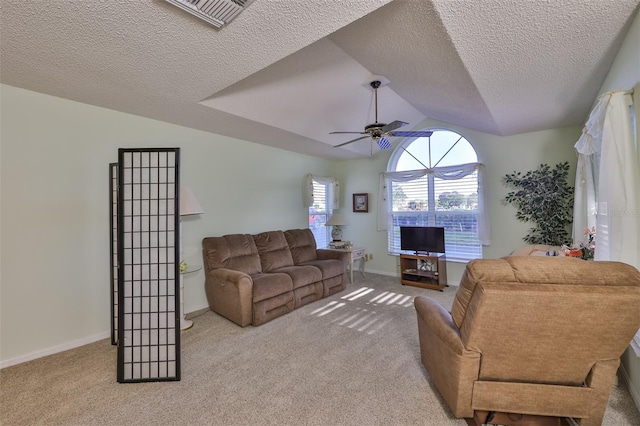 living room featuring light colored carpet, ceiling fan, and a textured ceiling