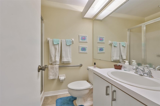 bathroom featuring toilet, tile flooring, walk in shower, and vanity