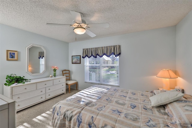 carpeted bedroom with a textured ceiling and ceiling fan