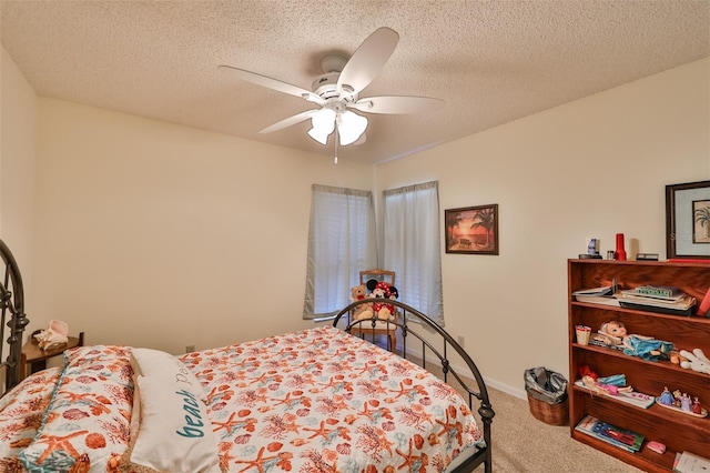 carpeted bedroom with a textured ceiling and ceiling fan