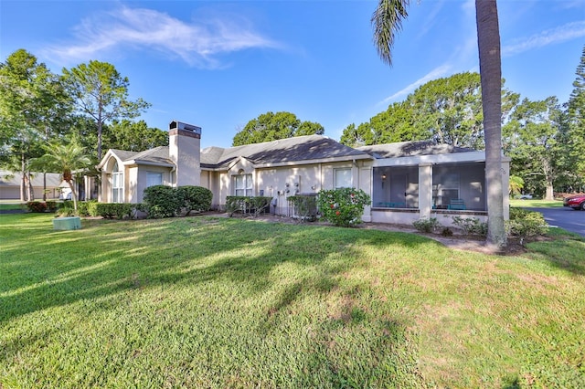 view of front of property featuring a sunroom, a front lawn, and central air condition unit