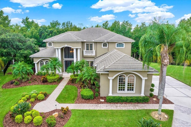 mediterranean / spanish house with a front yard