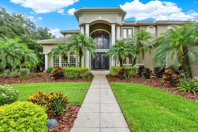 doorway to property featuring a yard and french doors