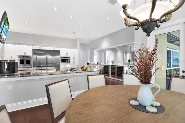 dining area featuring dark hardwood / wood-style flooring and a notable chandelier