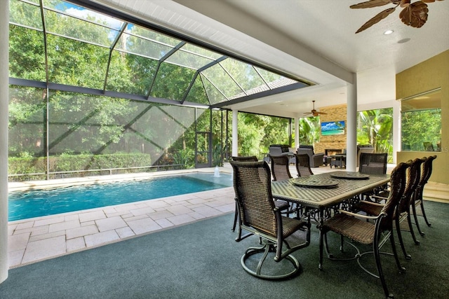 view of swimming pool featuring a lanai, ceiling fan, and a patio area