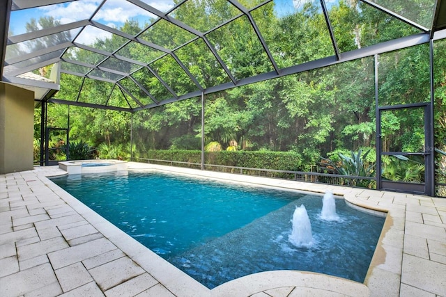 view of pool featuring an in ground hot tub, pool water feature, a lanai, and a patio area