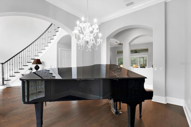 living area with dark wood-type flooring, ceiling fan, and ornamental molding