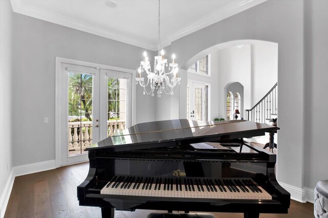 interior space featuring crown molding, wood-type flooring, a chandelier, and french doors