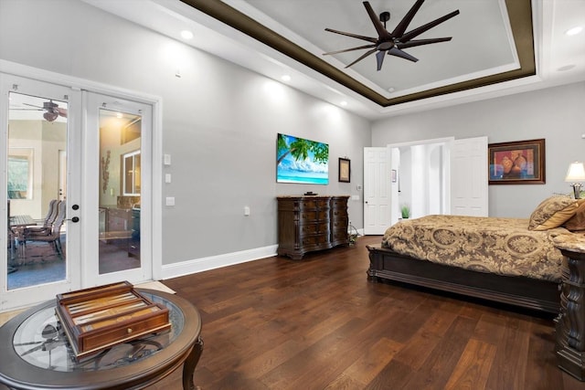 bedroom featuring french doors, dark hardwood / wood-style floors, a raised ceiling, ceiling fan, and access to exterior