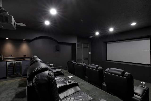 cinema with wine cooler, indoor wet bar, and carpet flooring