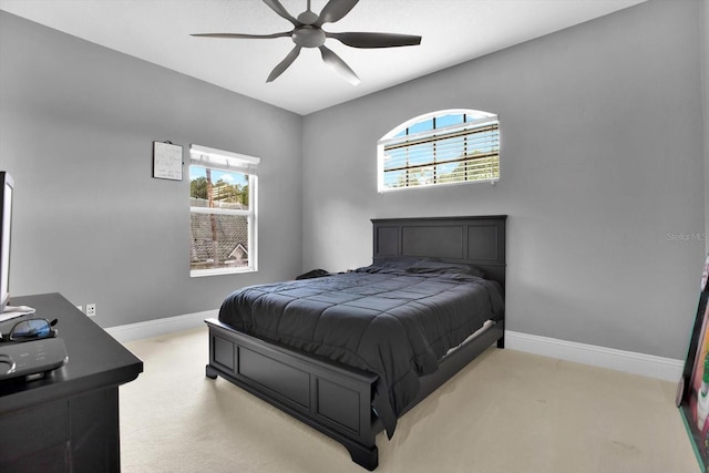 bedroom featuring light carpet and ceiling fan