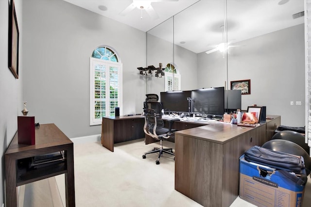 home office with light carpet and ceiling fan