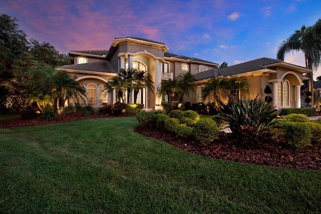 mediterranean / spanish house featuring a lawn