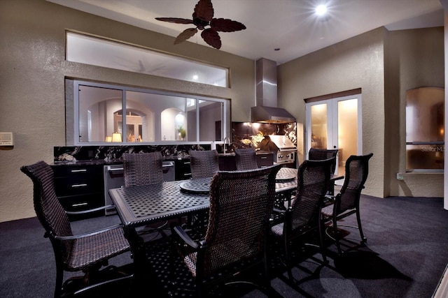 carpeted dining room featuring ceiling fan