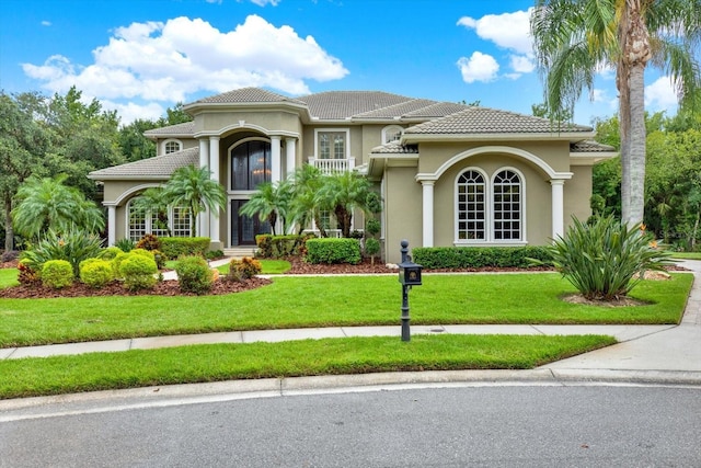 mediterranean / spanish-style home with a front lawn