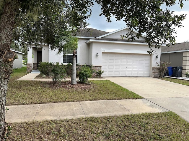 ranch-style house with a garage and a front yard