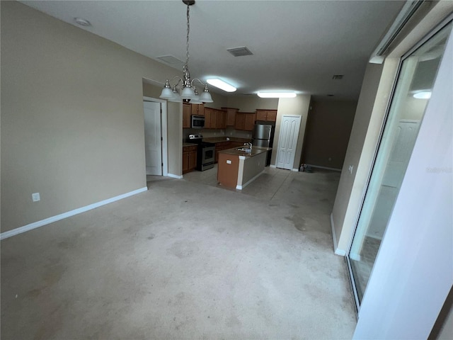 kitchen with stainless steel appliances, a kitchen island, sink, and decorative light fixtures