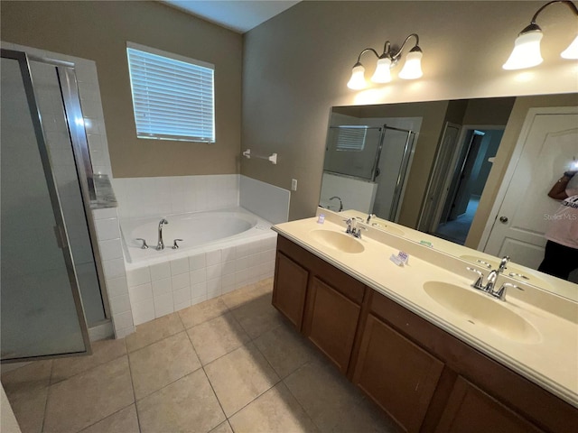 bathroom with tile patterned flooring, vanity, and shower with separate bathtub