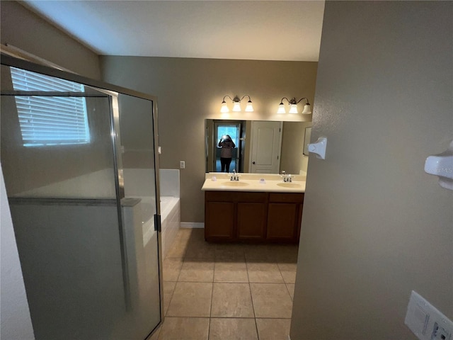 bathroom featuring tile patterned flooring, vanity, and shower with separate bathtub