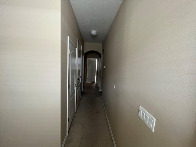 hallway featuring a textured ceiling