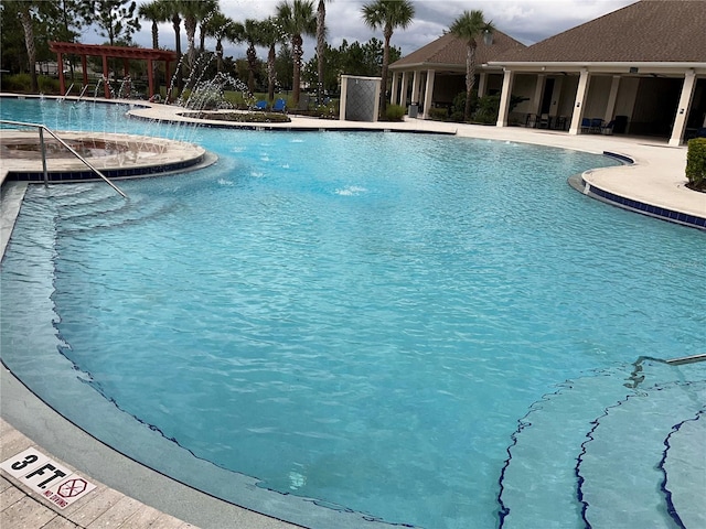 view of pool featuring pool water feature and a pergola