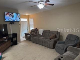 carpeted living room featuring ceiling fan