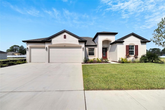 view of front of house with a garage and a front lawn