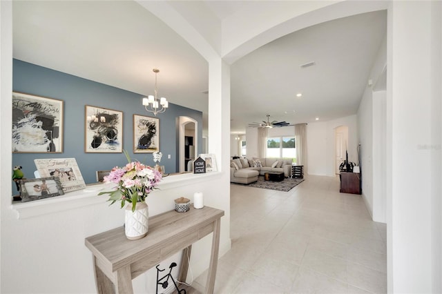 interior space with a notable chandelier and light tile flooring