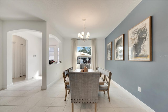 dining area with a notable chandelier and light tile floors