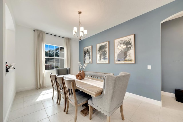 dining space featuring a chandelier and light tile flooring