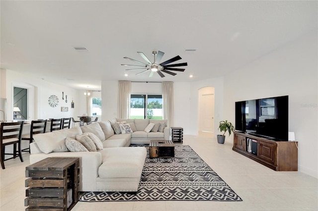 living room with light tile flooring and ceiling fan