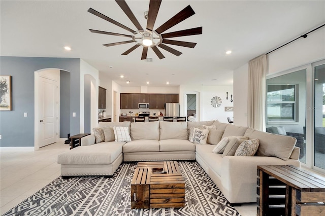 living room featuring ceiling fan and light tile floors