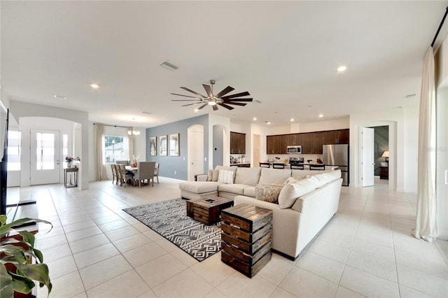 tiled living room with ceiling fan