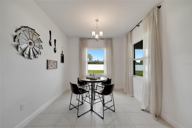 tiled dining room with a notable chandelier