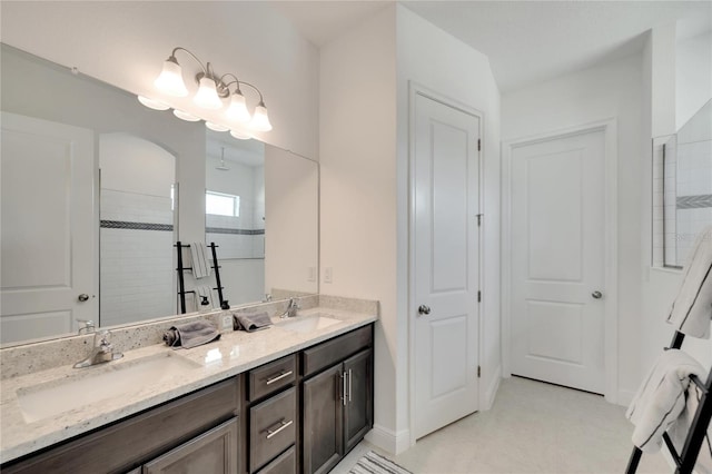 bathroom with tile flooring, large vanity, and double sink