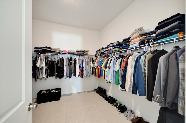 walk in closet featuring tile flooring