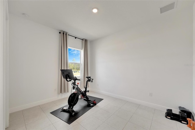 exercise room with light tile flooring