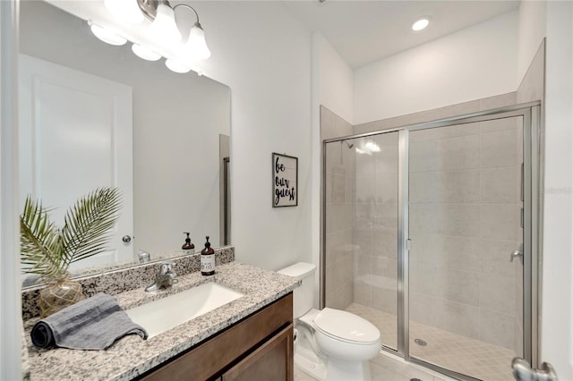 bathroom featuring an enclosed shower, toilet, and vanity