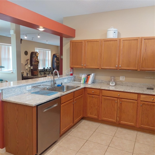 kitchen featuring stainless steel dishwasher, kitchen peninsula, and light tile patterned floors